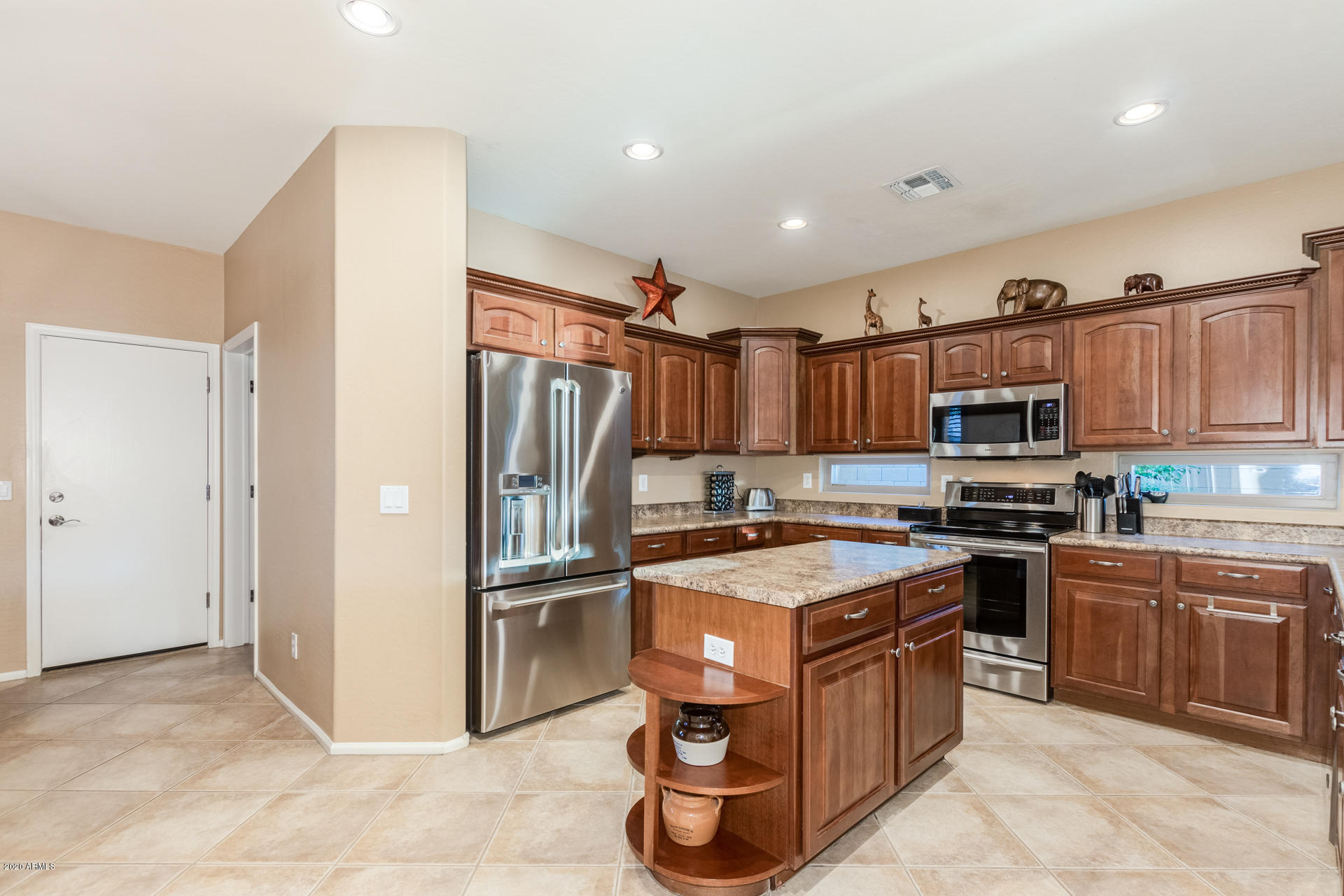 4549 East Ruffian Road Gilbert, AZ 85297 - Photo 12 of 52 a kitchen with stainless steel appliances granite countertop a refrigerator stove and sink