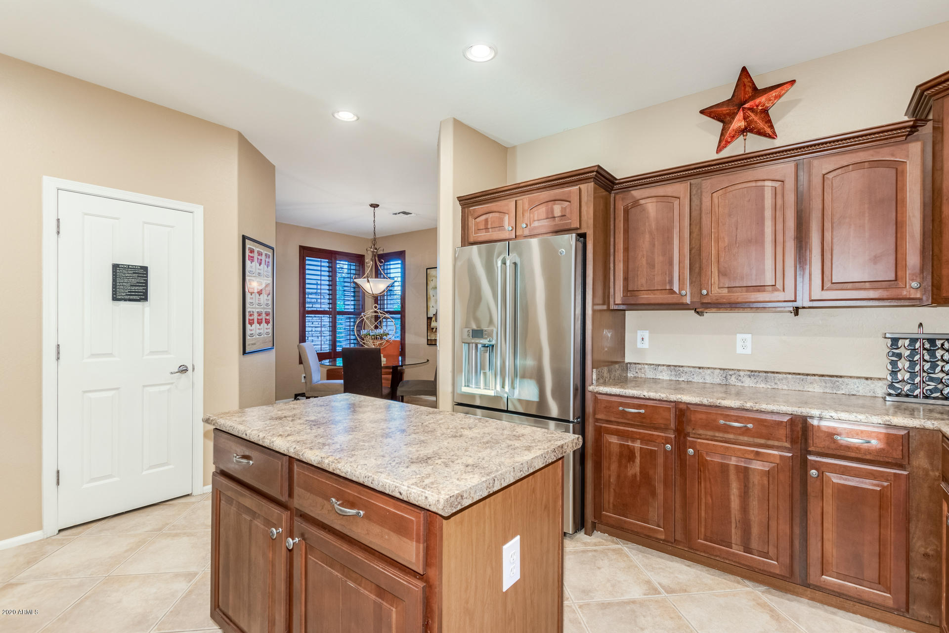 4549 East Ruffian Road Gilbert, AZ 85297 - Photo 15 of 52 a kitchen with granite countertop a refrigerator and a sink
