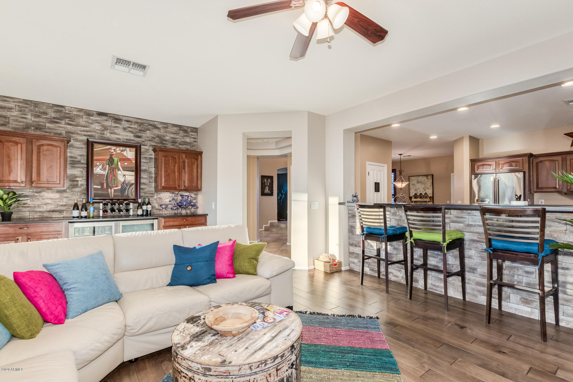 4549 East Ruffian Road Gilbert, AZ 85297 - Photo 17 of 52 a living room with furniture kitchen view and a wooden floor
