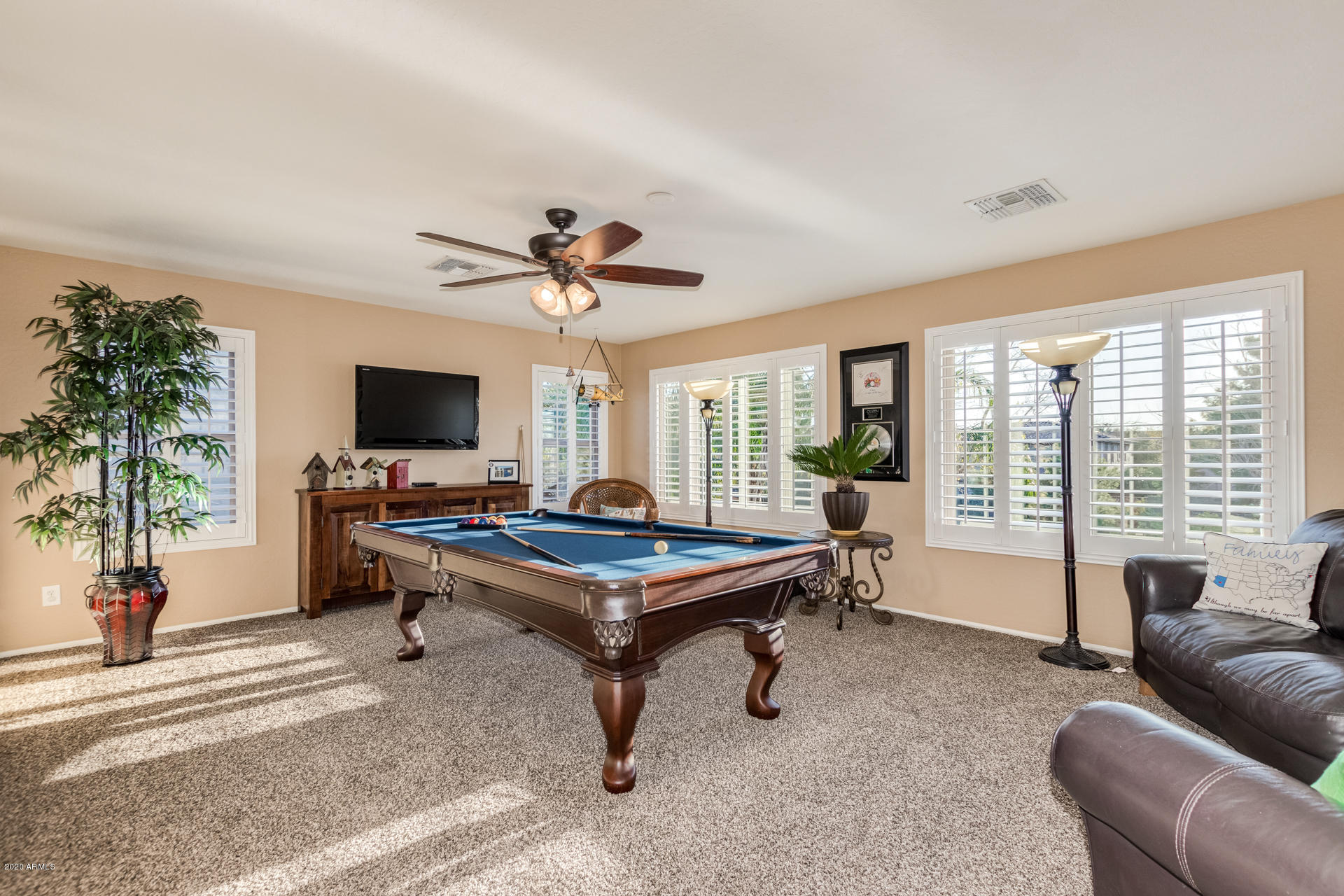 4549 East Ruffian Road Gilbert, AZ 85297 - Photo 27 of 52 a living room with furniture and a flat screen tv