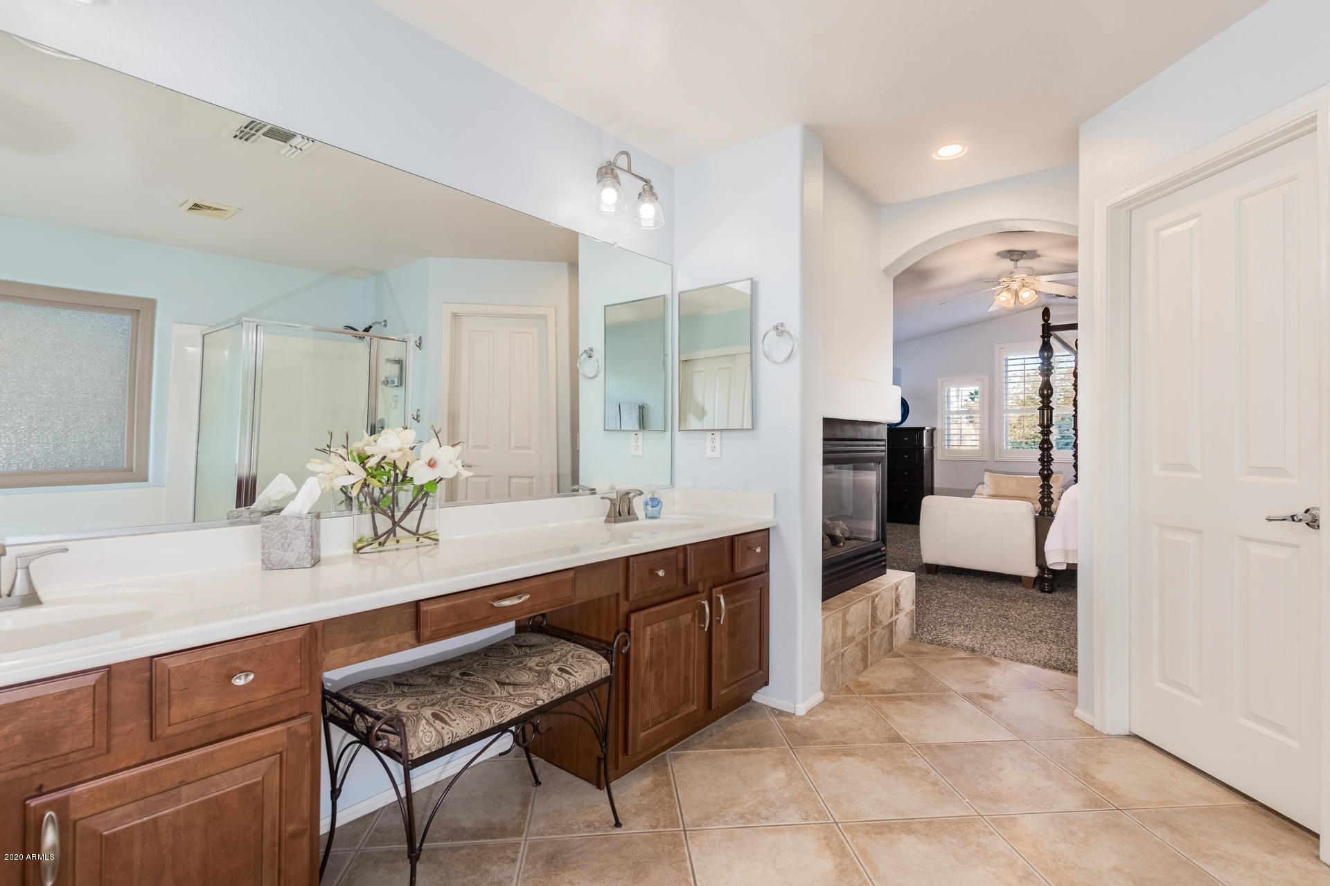 4549 East Ruffian Road Gilbert, AZ 85297 - Photo 32 of 52 a spacious bathroom with a granite countertop sink a mirror and a shower
