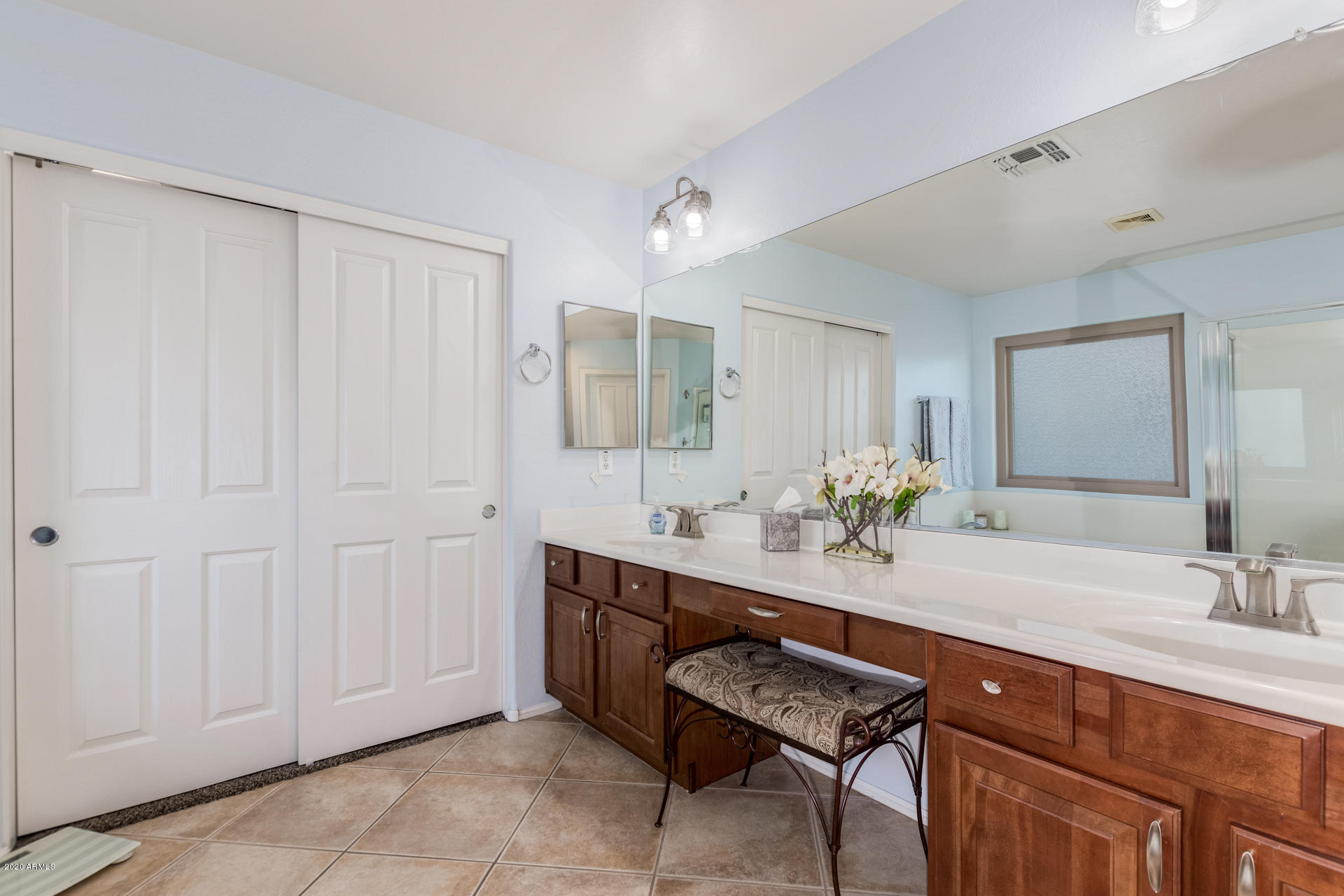 4549 East Ruffian Road Gilbert, AZ 85297 - Photo 34 of 52 a bathroom with a double vanity sink and a mirror