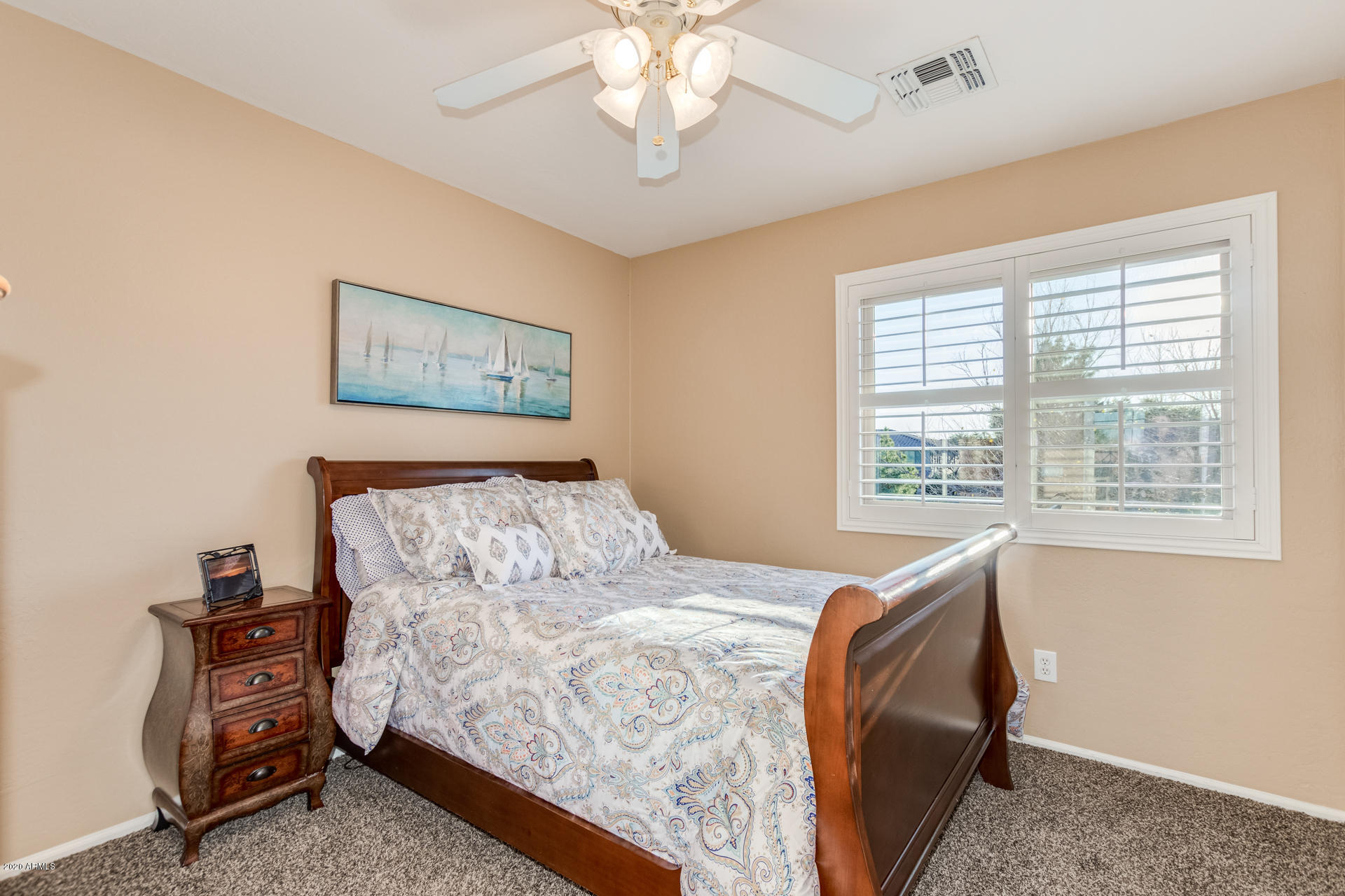 4549 East Ruffian Road Gilbert, AZ 85297 - Photo 36 of 52 a bed sitting in a bedroom next to a window