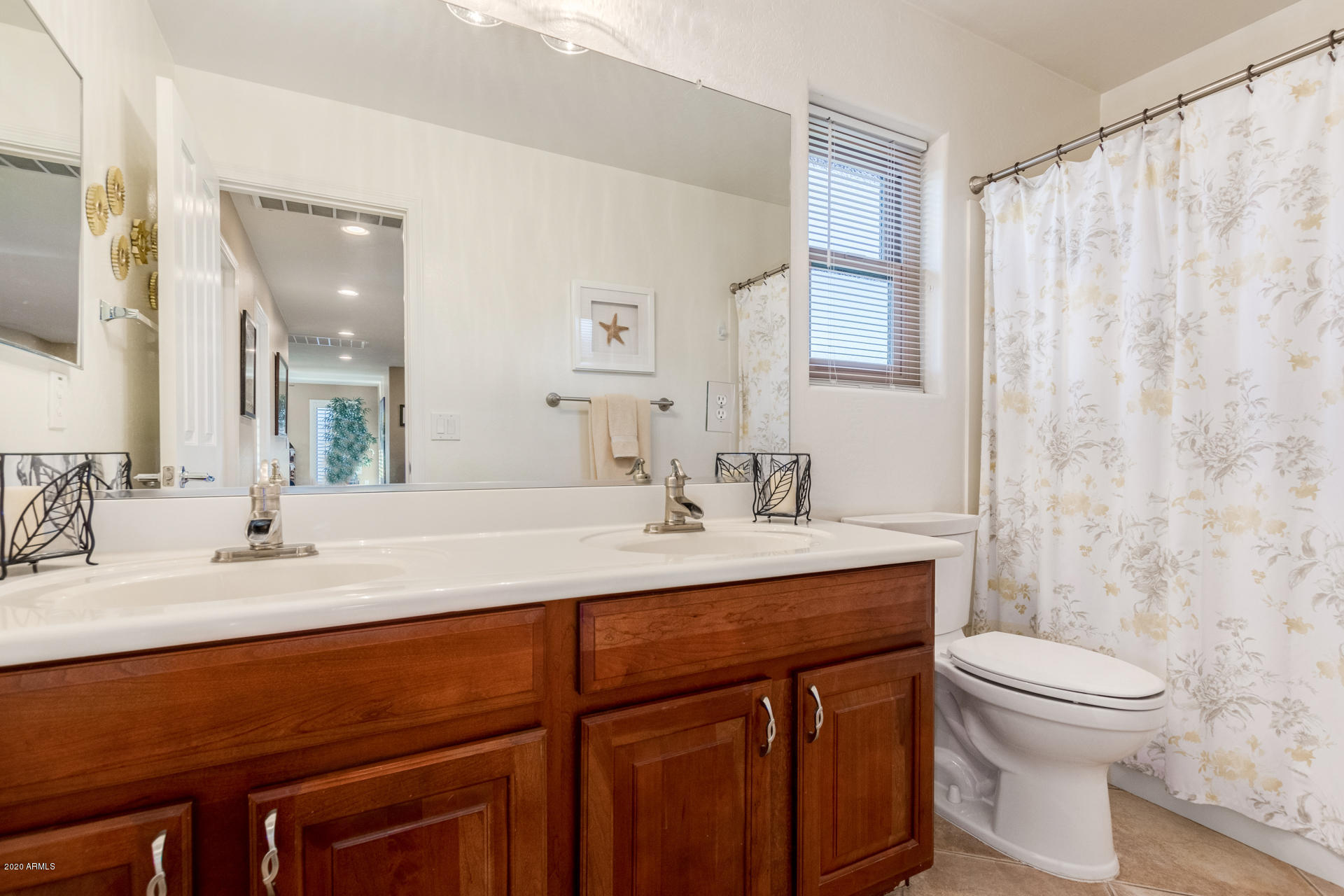 4549 East Ruffian Road Gilbert, AZ 85297 - Photo 38 of 52 a bathroom with a sink a toilet and a mirror