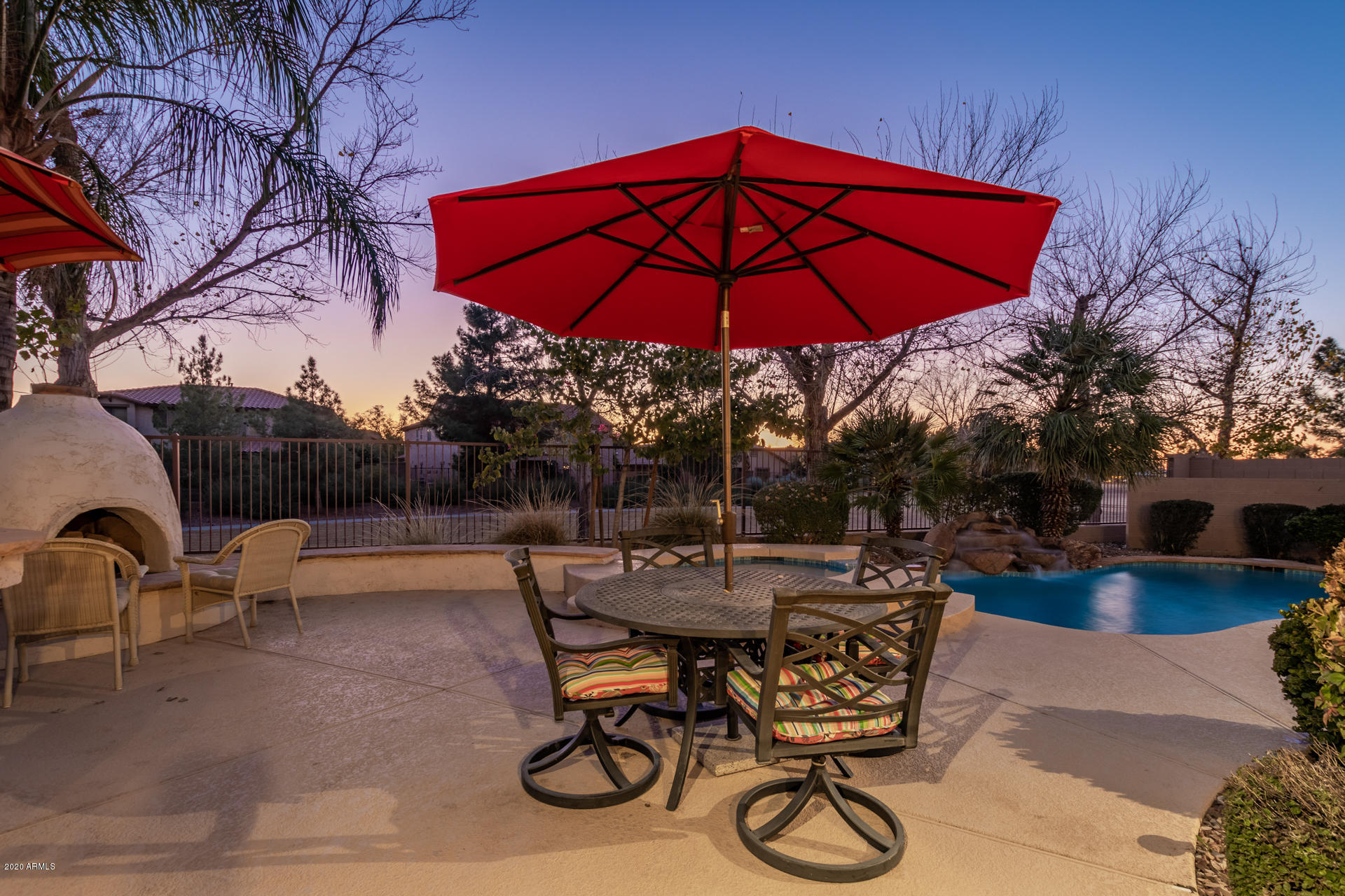 4549 East Ruffian Road Gilbert, AZ 85297 - Photo 45 of 52 a view of patio with chairs and table under an umbrella