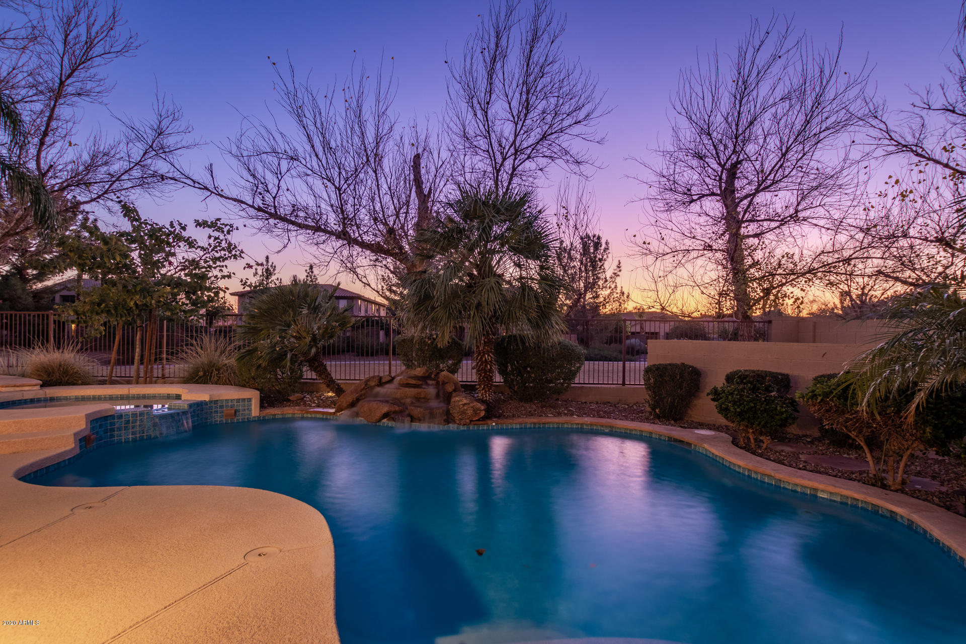 4549 East Ruffian Road Gilbert, AZ 85297 - Photo 47 of 52 a backyard of a house with table and chairs under an umbrella