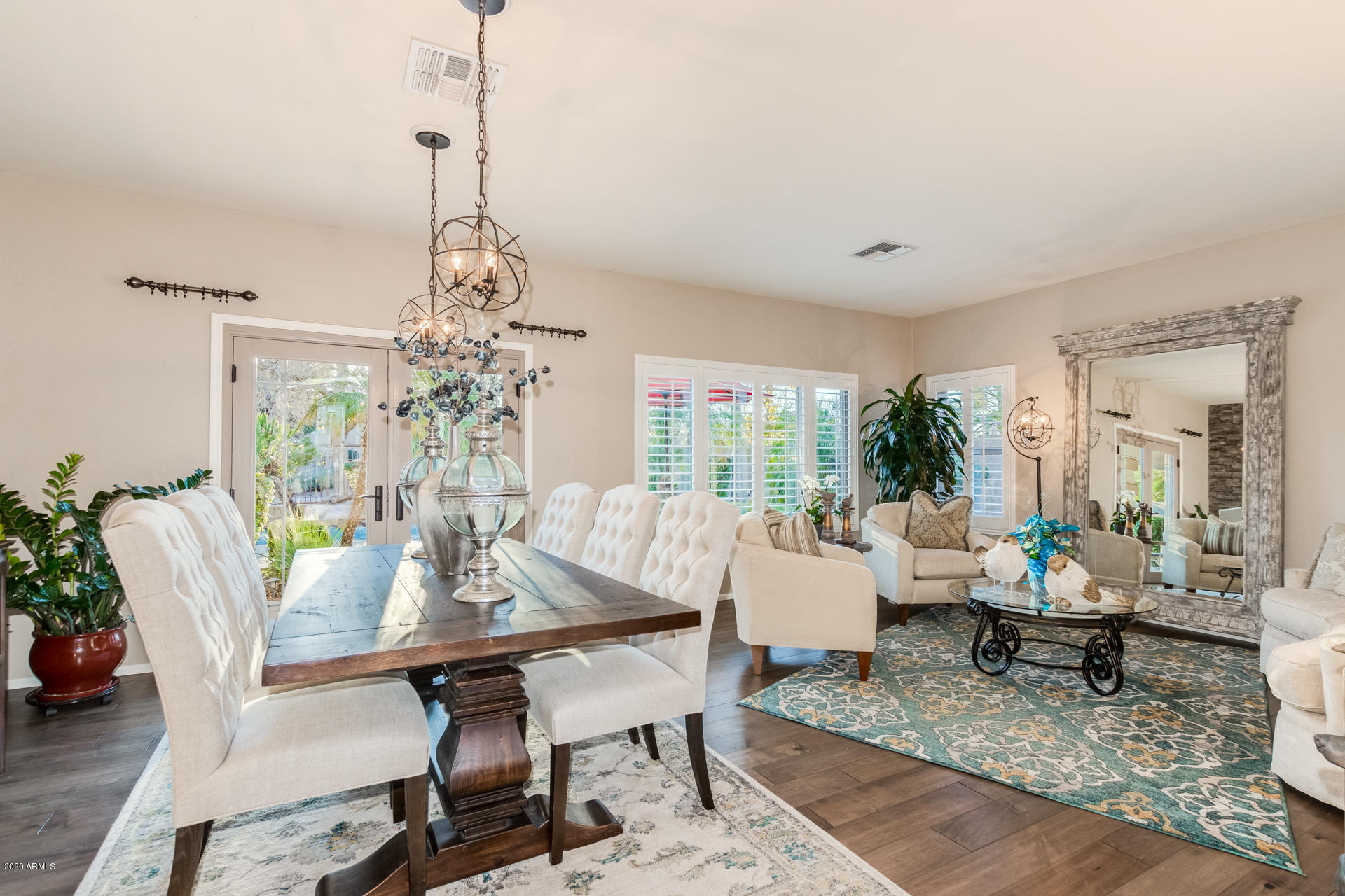 4549 East Ruffian Road Gilbert, AZ 85297 - Photo 5 of 52 a view of a dining room with furniture window and wooden floor