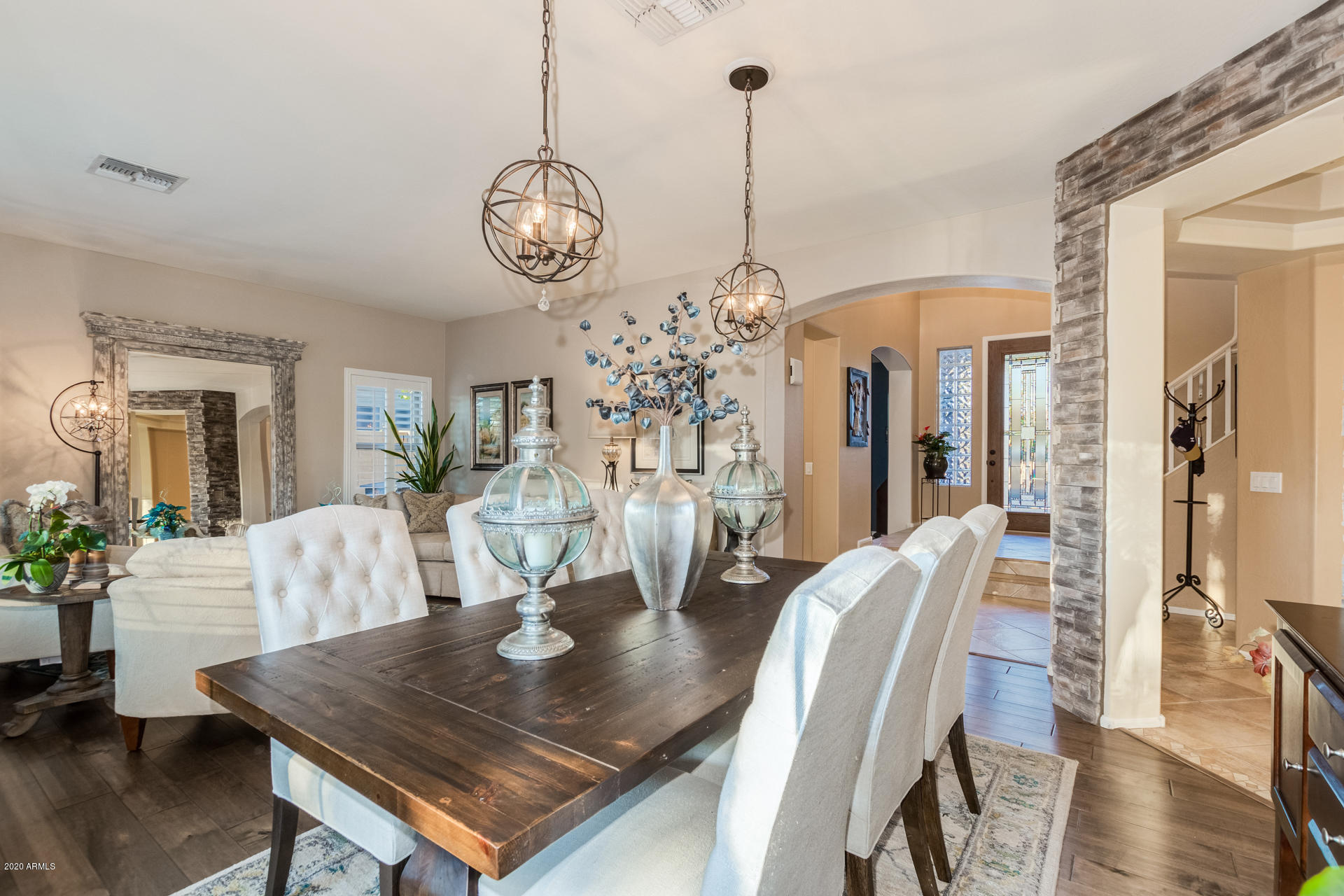 4549 East Ruffian Road Gilbert, AZ 85297 - Photo 9 of 52 a view of a dining room with furniture wooden floor and chandelier