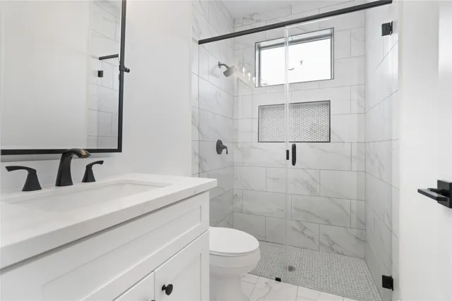 a bathroom with a sink toilet and shower