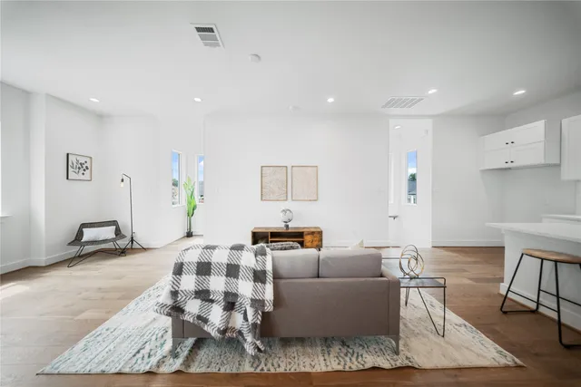 a living room with furniture and wooden floor