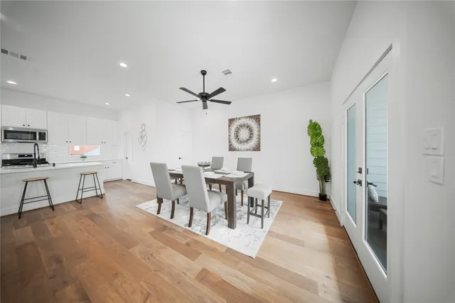 a view of a dining room with furniture and chandelier