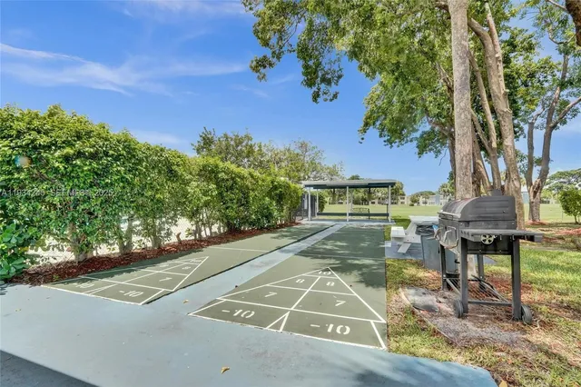 a view of a yard with table and chairs and a fire pit