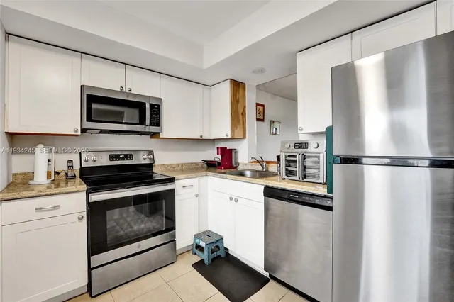 a kitchen with a refrigerator stove and microwave
