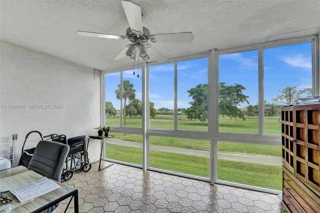 a living room with lots of furniture and a floor to ceiling window
