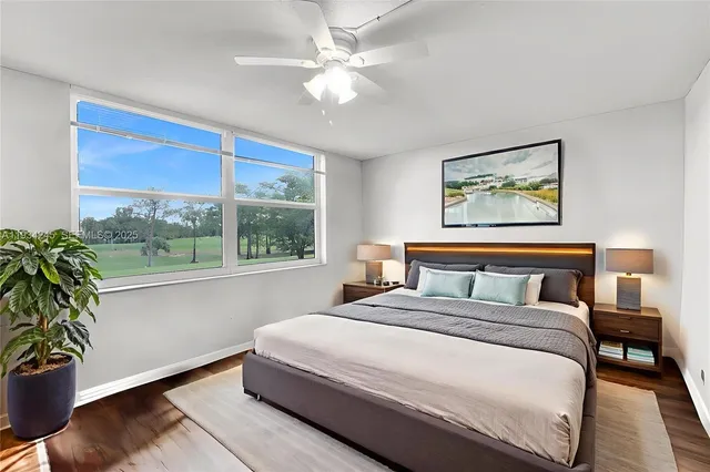 a bedroom with a large bed and a potted plant