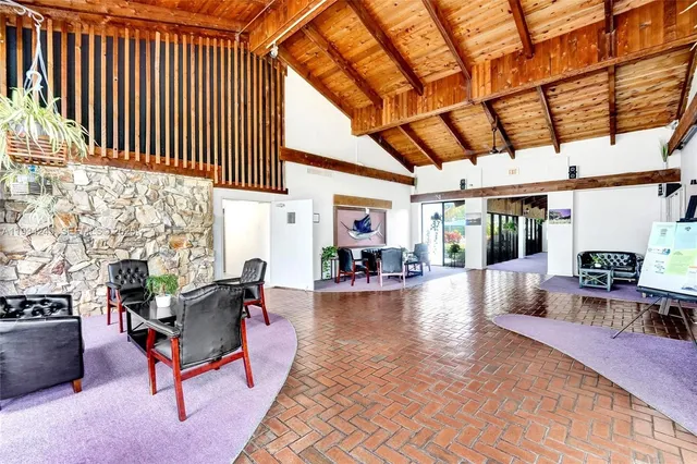 a hallway with beautiful frames and flower vase