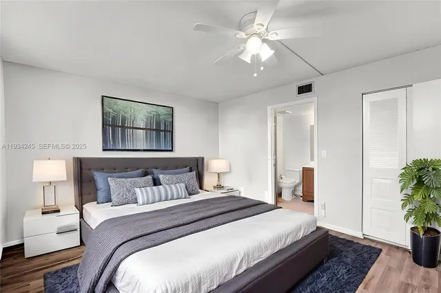 a bedroom with bed and a potted plant