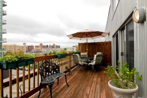 203 South Sangamon Street, Unit 310 Chicago, IL 60607 - Photo 12 of 16 a view of a balcony with chair and wooden floor