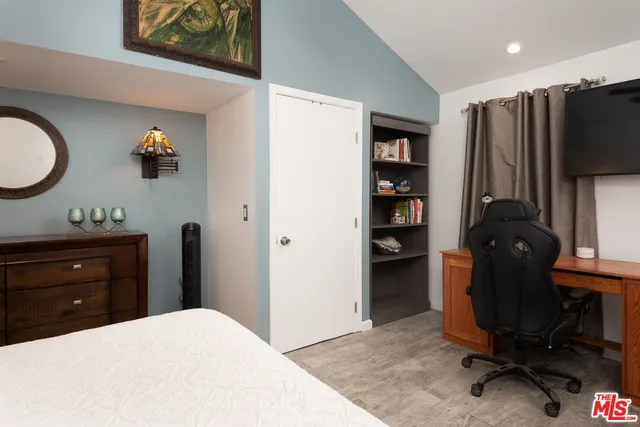 a bedroom with a bed and a television