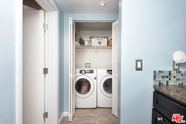 a utility room with sink dryer and washer