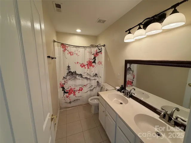 a bathroom with a sink double vanity and mirror