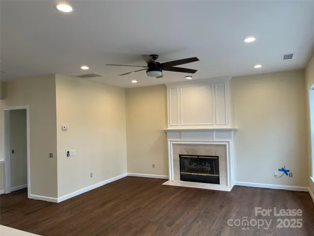 a view of an empty room with a fireplace and a window