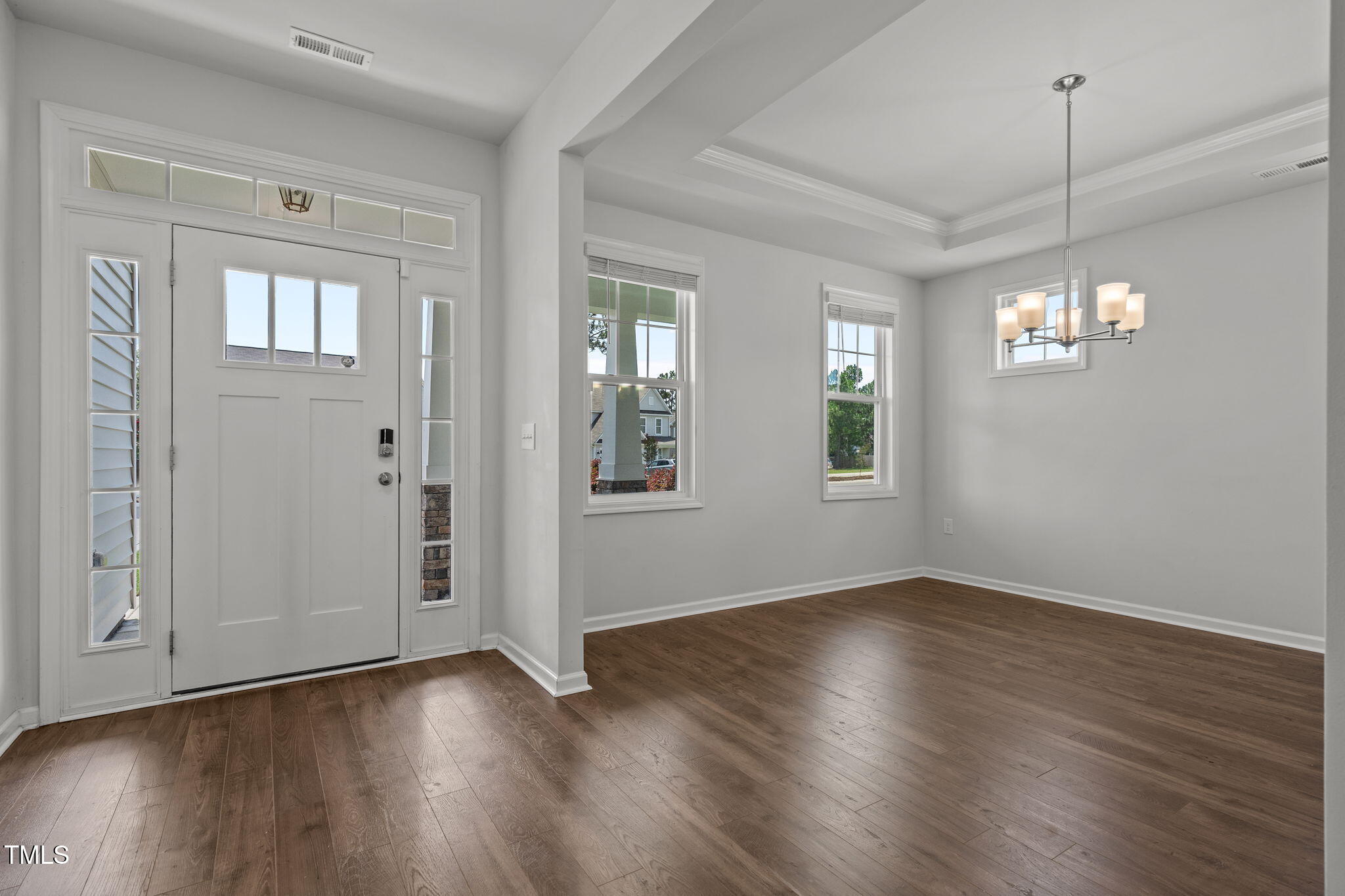 131 Sandy Springs Road Aberdeen, NC 28315 - Photo 10 of 61 an empty room with wooden floor chandelier and windows