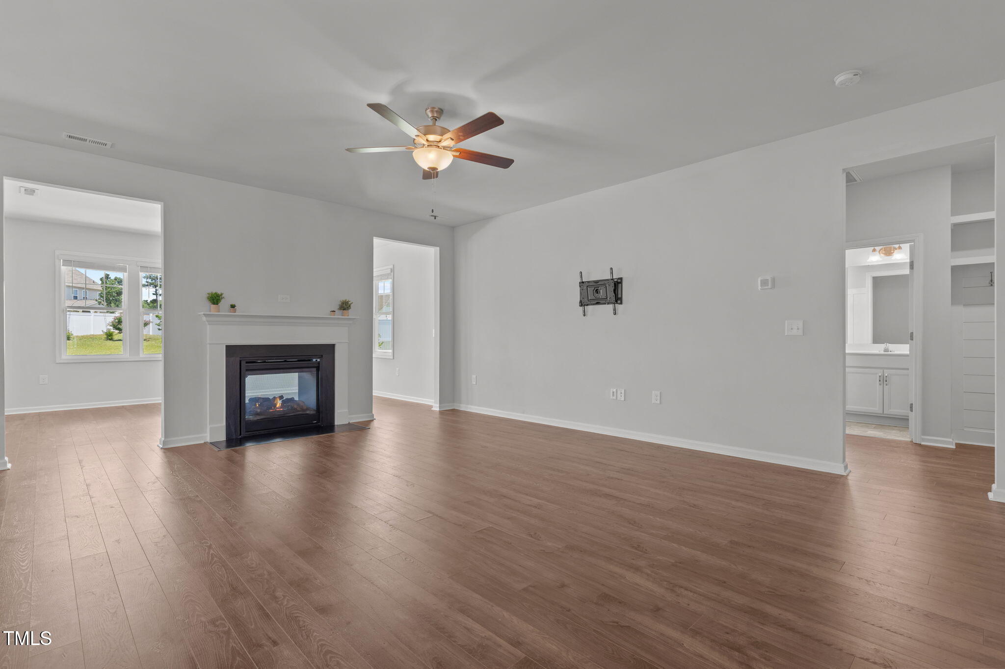 131 Sandy Springs Road Aberdeen, NC 28315 - Photo 22 of 61 a view of empty room with wooden floor and fireplace