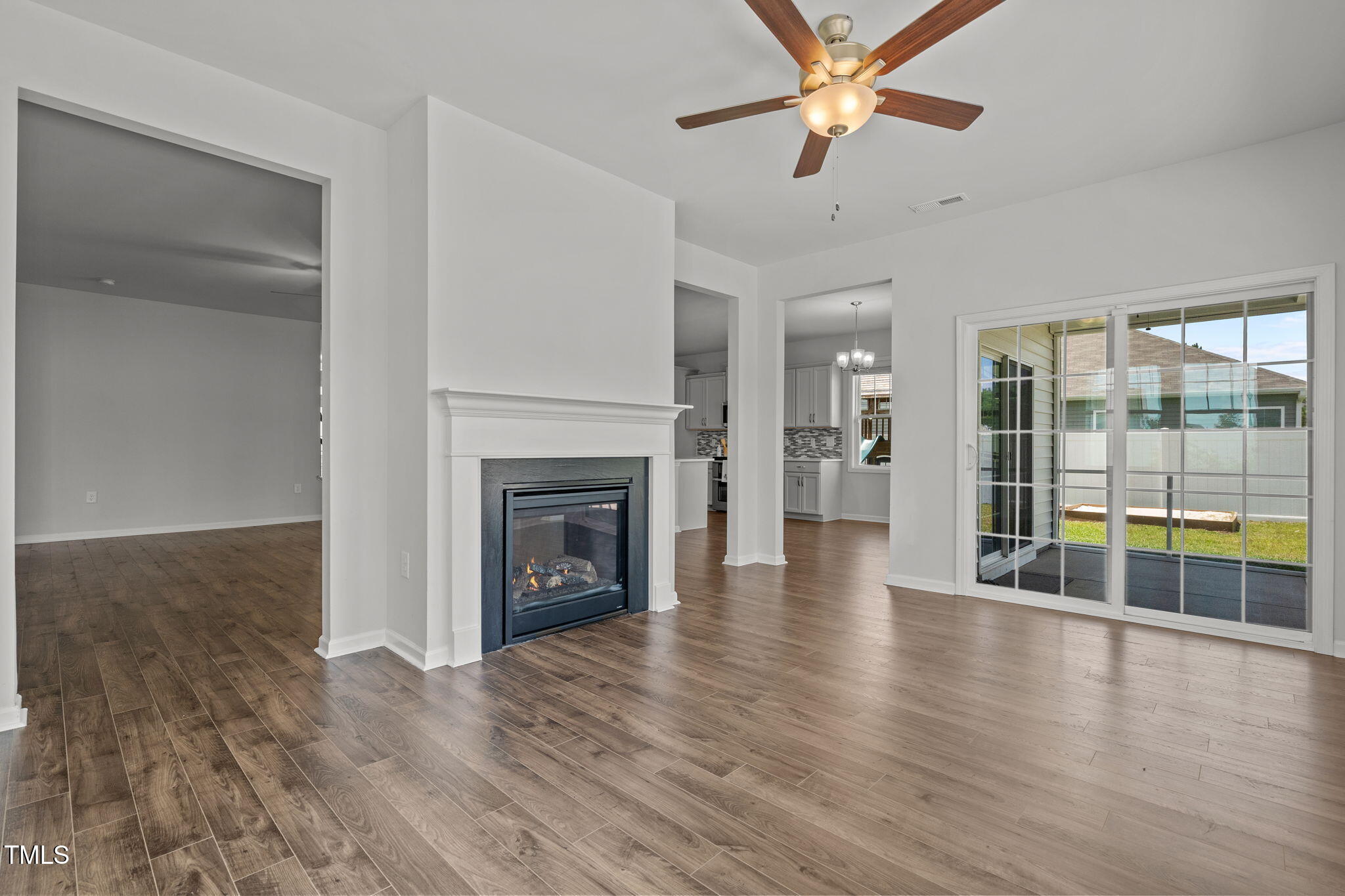 131 Sandy Springs Road Aberdeen, NC 28315 - Photo 25 of 61 a view of a livingroom with wooden floor a ceiling fan and windows
