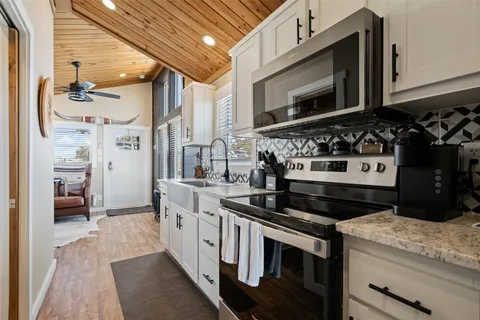 a kitchen with stainless steel appliances granite countertop a stove and a microwave
