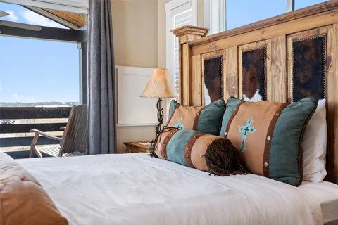 a bed sitting in a bedroom next to a window