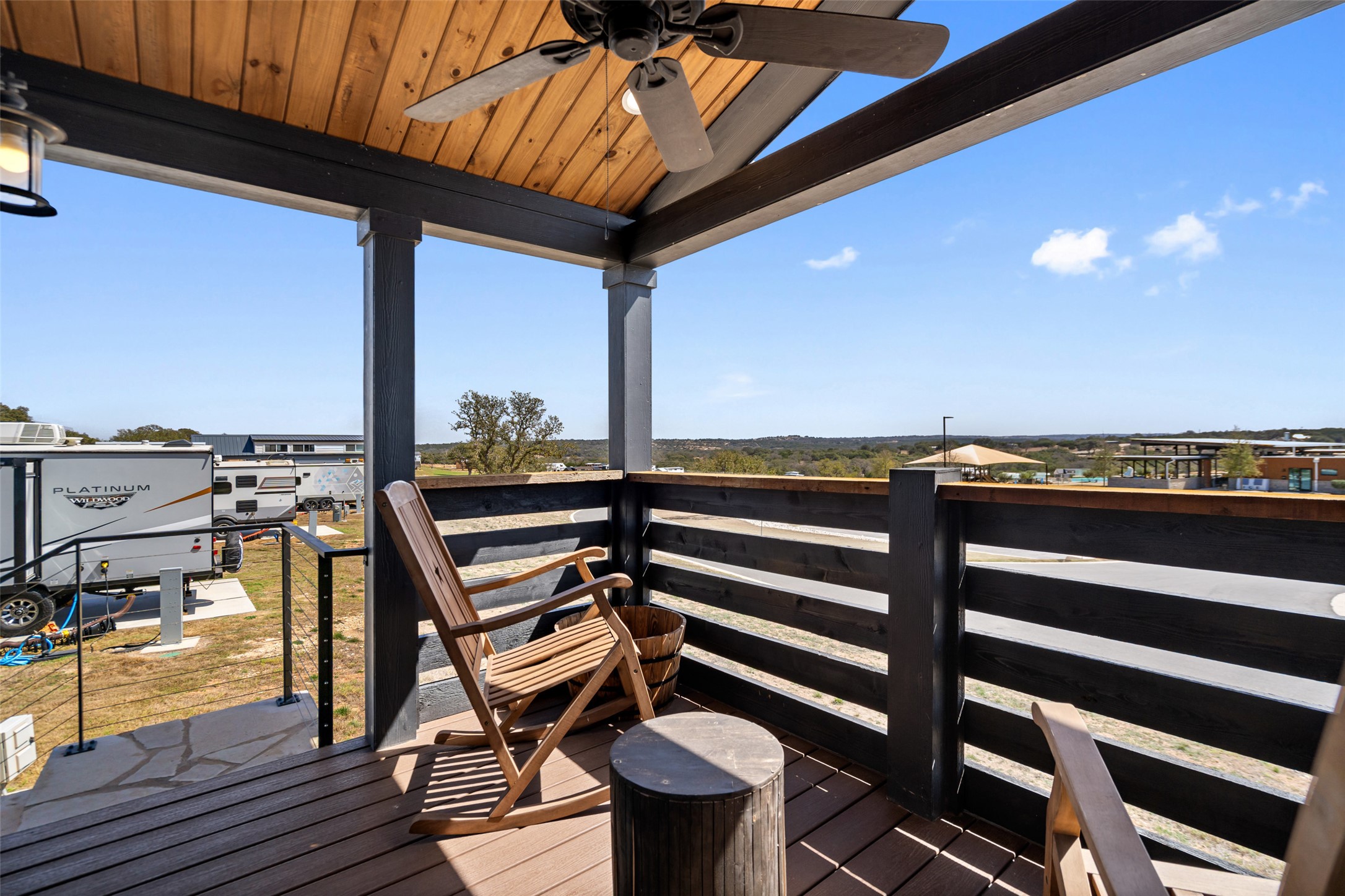 5386 Ranch Road 1376, Unit 50 Fredericksburg, TX 78624 - Photo 19 of 32 a view of a balcony with chairs and a table