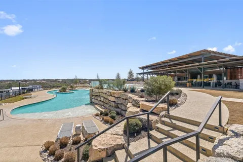 a view of a swimming pool and lounge chairs