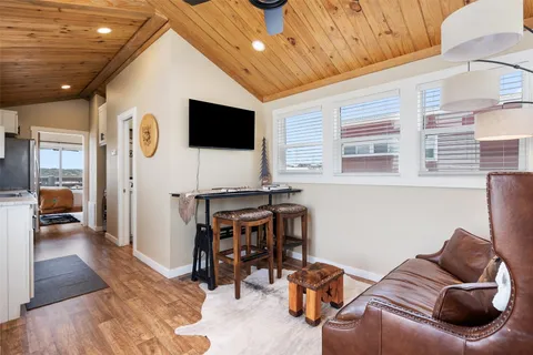 a view of a livingroom with furniture and a flat screen tv