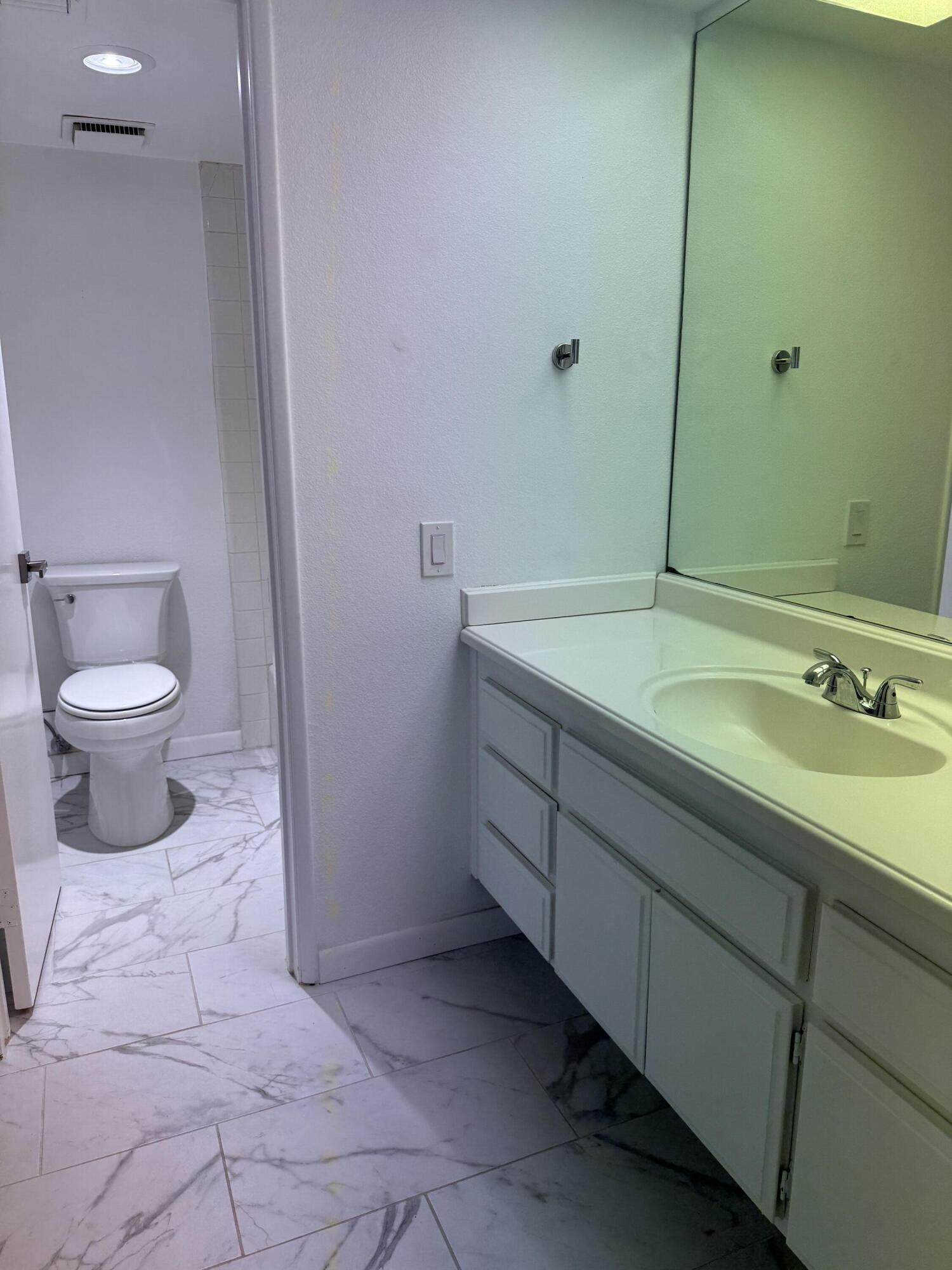 2017 Normandy Court Palm Springs, CA 92264 - Photo 14 of 17 a bathroom with a toilet sink and mirror