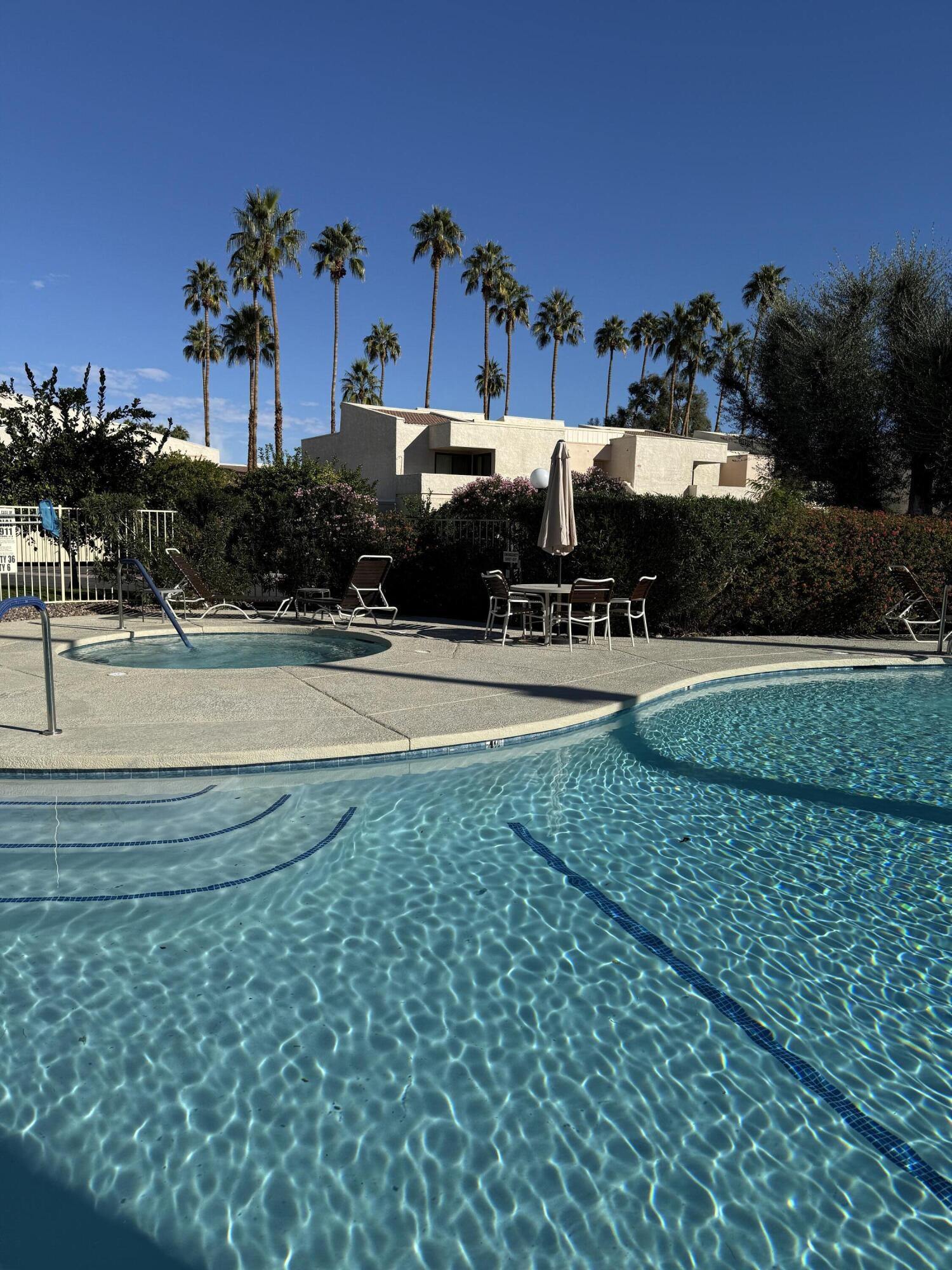 2017 Normandy Court Palm Springs, CA 92264 - Photo 2 of 17 a front view of a house with a yard and garage