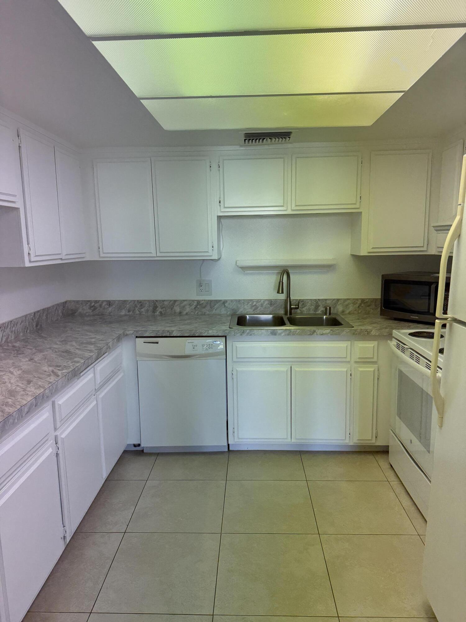 2017 Normandy Court Palm Springs, CA 92264 - Photo 4 of 17 a kitchen with a stove sink and cabinets