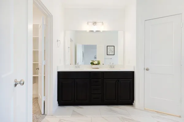 a bathroom with a sink vanity and mirror
