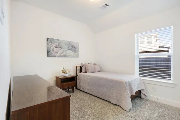 a bedroom with a bed and a table