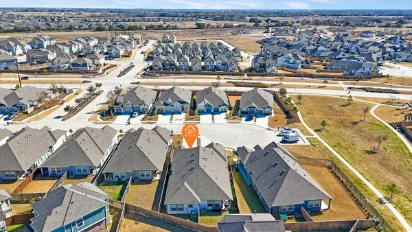an aerial view of residential houses with outdoor space
