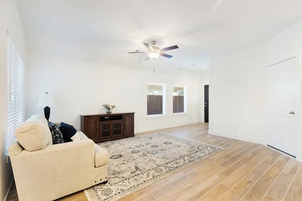a living room with furniture and wooden floor
