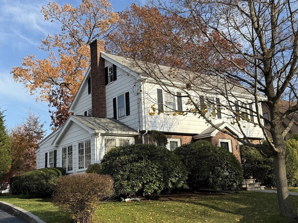 11 Randlett Park Newton, MA 02465 - Photo 2 of 3 a front view of a house with a garden and trees