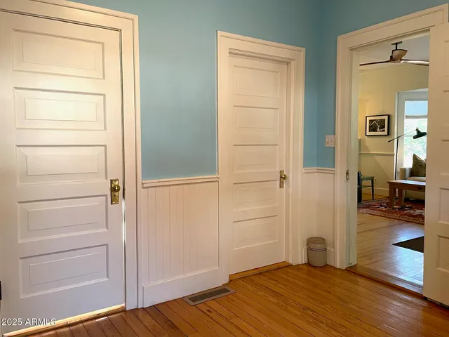 a view of a room with wooden floor and furniture