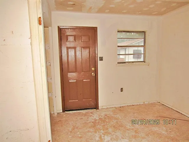 an empty room with windows and closet