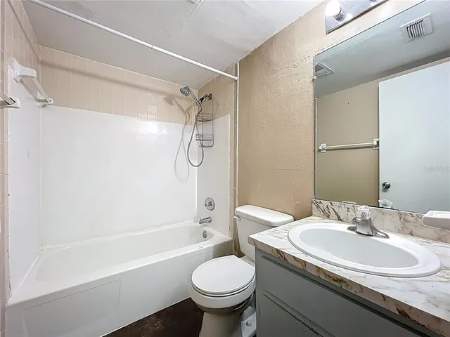 a bathroom with a sink toilet tub and shower