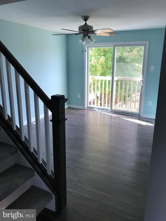 a view of an entryway with wooden floor