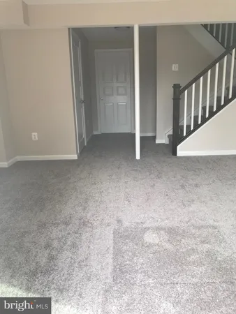 a view of a big room with closet and stairs