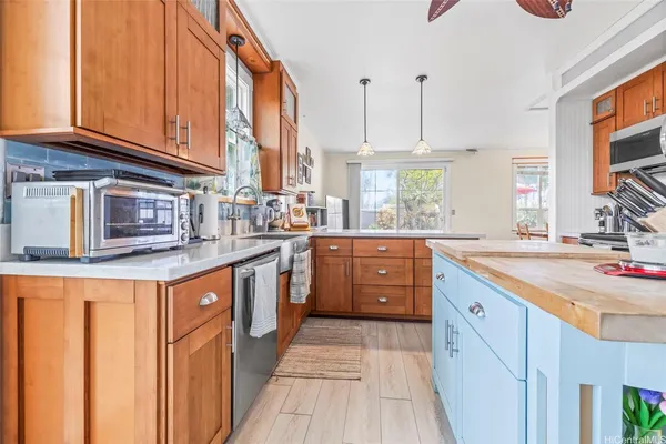 a kitchen with stainless steel appliances kitchen island granite countertop a sink and cabinets