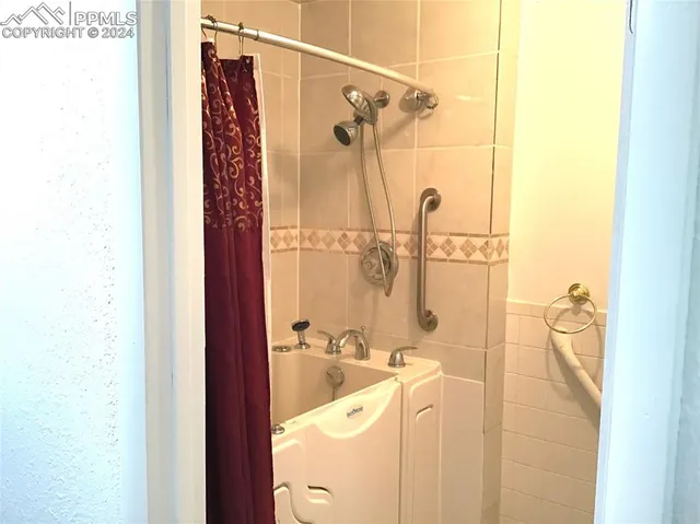 a bathroom with a sink a mirror and shower