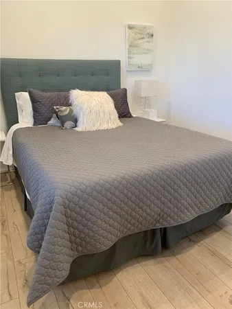 a bedroom with a bed and a night stand
